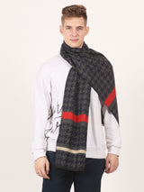 Men’s black houndstooth muffler with a bold red stripe, cream border detail, and fringed edge.