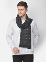 Close-up of a black and white printed men’s muffler with small square motifs.
