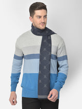 Close-up of a navy blue and grey printed men’s muffler with monogram geometric pattern.