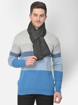 Close-up of a black and grey striped men’s muffler with wavy line pattern and Cazzano label.