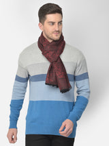 Close-up of a maroon and black printed men’s muffler with ornamental patchwork pattern.