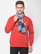 Man wearing a grey blue and black checked muffler.