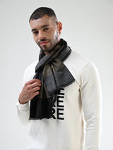 Man wearing a black and beige striped men’s muffler with fine diagonal line pattern.