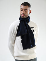 Man wearing a solid navy blue men’s muffler with fringed edges.