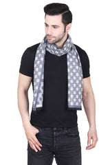 Navy blue and grey checked men’s muffler with mosaic grid pattern and fringed edge on a white background.