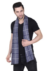 Navy blue and grey checked men’s muffler with windowpane plaid pattern and fringed edge on a white background.