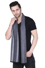 Man wearing a black and grey striped men’s muffler with fine diagonal pattern on a white background