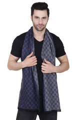 Navy blue and grey printed men’s muffler with repeating geometric pattern, solid borders and fringed edge on a white background.
