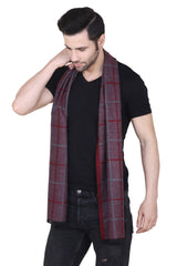 Burgundy and navy checked men’s muffler with tartan plaid pattern and fringed edge on a white background.