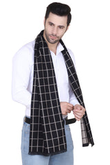 Man wearing a black and white checked men’s muffler with windowpane pattern on a white background.