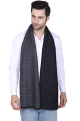 Black and charcoal grey printed men’s muffler with micro-square textured pattern and fringed edge on a white background.