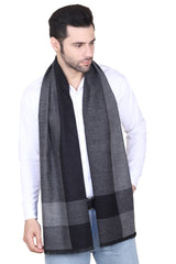 Man wearing a grey and black checked men’s muffler with colour-block pattern on a white background.
