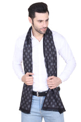 Black and charcoal grey checked men’s muffler with small grid pattern and fringed edge on a white background.