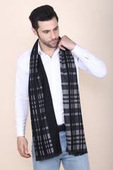 Man wearing a black and grey checked men’s muffler with tartan plaid pattern.