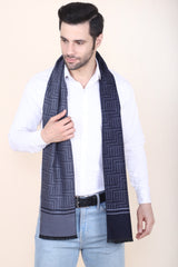 Man wearing a navy blue and grey printed men’s muffler with Greek key geometric pattern and solid border panels.