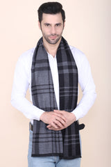 Man wearing a grey and black checked men’s muffler with tartan plaid pattern.
