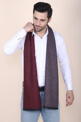 Man wearing a black and red printed men’s muffler with small square motif pattern.