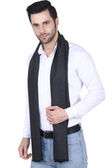 Solid charcoal black men’s muffler with fringed edge on a white background.
